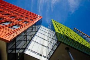 Looking up at a colorful building with a blue sky in the background