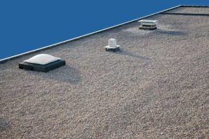 There are three skylights on the roof of a building.