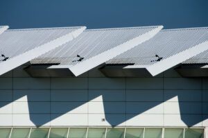 A close up of the roof of a building with a blue sky in the background.