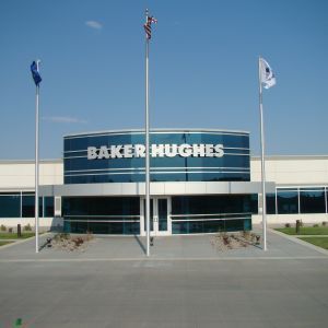 Baker Hughes building entrance with flags on a sunny day.