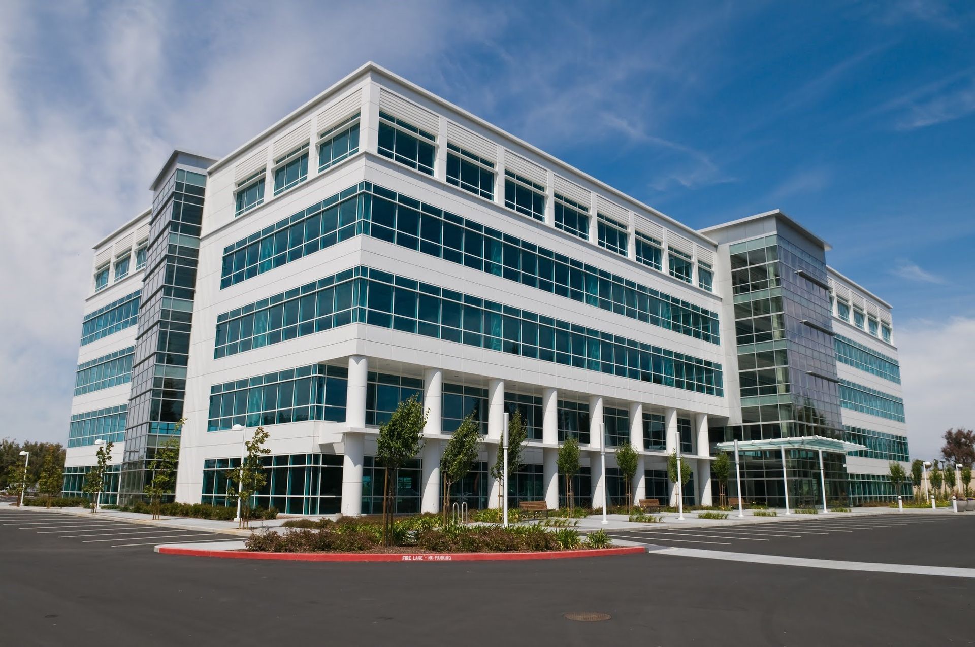 A large white and blue building with a lot of windows