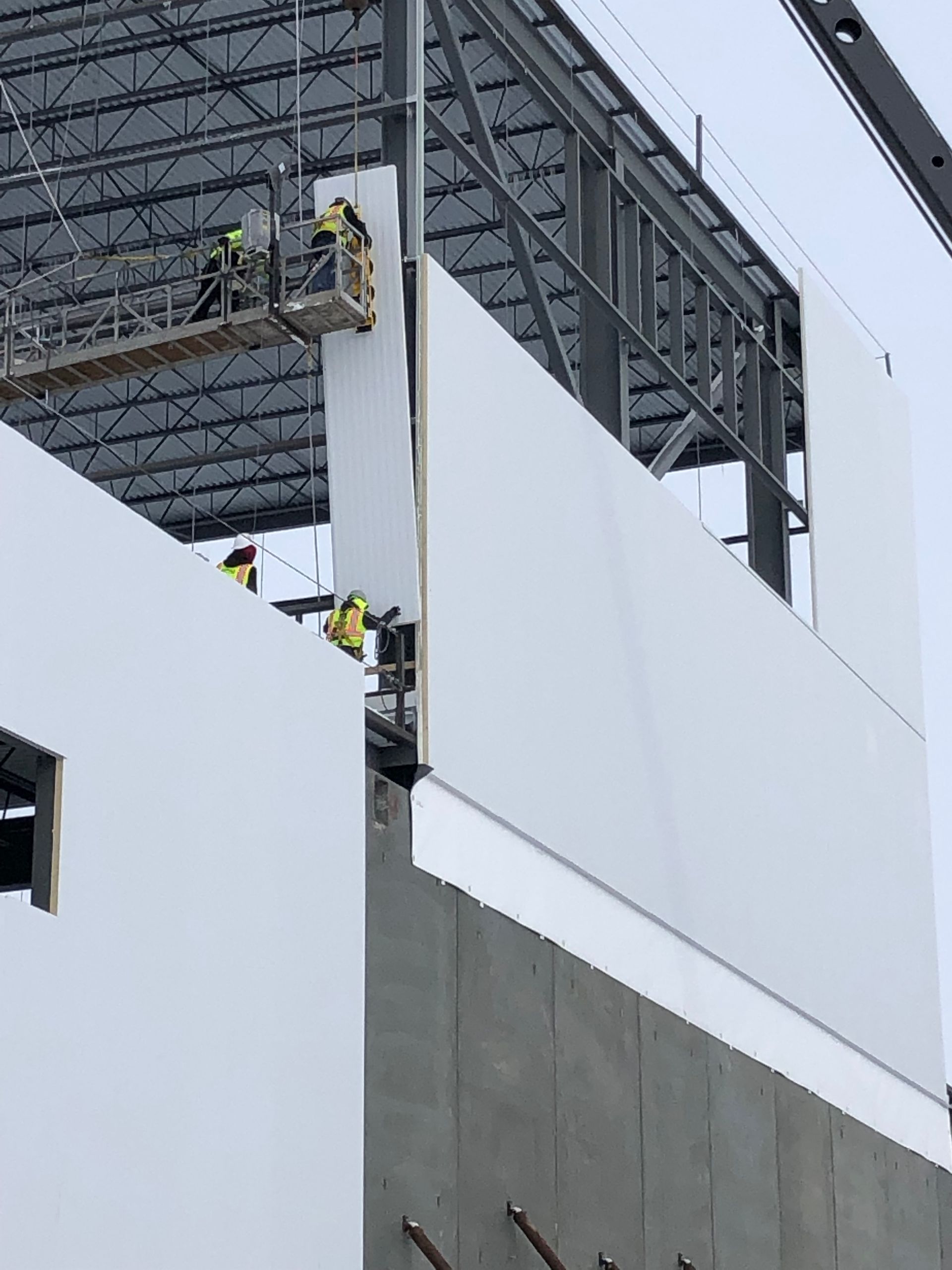 A group of construction workers are working on a building.