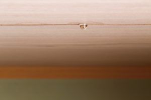 A drop of water is dripping from the ceiling of a room.