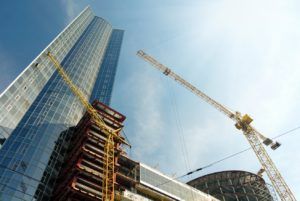 A building is being built with cranes in front of it.