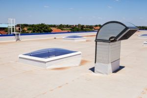 There are two skylights on the roof of a building.
