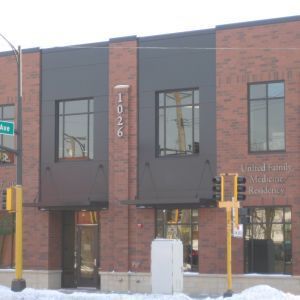 Brick building with dark gray accents and windows, 