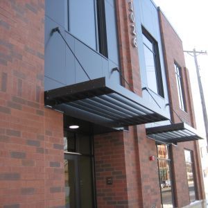 Red brick building with black awning over door and window.  Address 1022.
