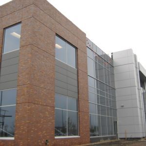 Modern brick and metal building with large windows.