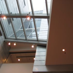 Skylight in a modern building with metal beams and recessed lights.