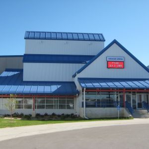 Blue and white building with a blue roof and the name 