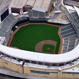Aerial view of Target Field baseball stadium, green grass, brown infield, seating, and surrounding structures.