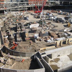 Construction site with concrete structures, machinery, and materials.