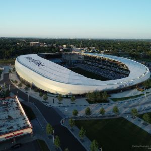 Aerial view of Allianz Field, a soccer stadium, with a white curved roof.
