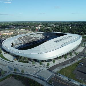 Aerial view of Allianz Field soccer stadium in St. Paul, Minnesota, with fans in the stands, gray exterior.