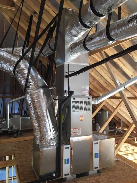 An air conditioner is sitting in the attic of a house