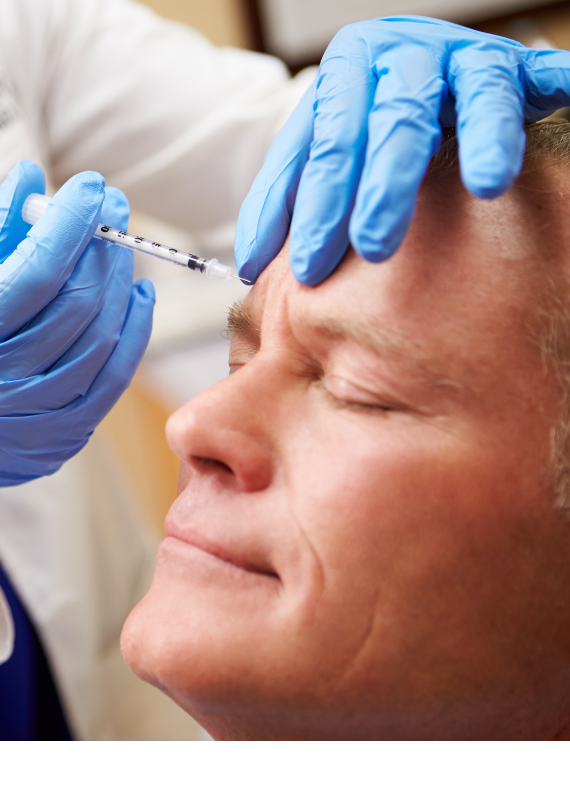 A woman is getting a Botox treatment with an injection around her eyes.