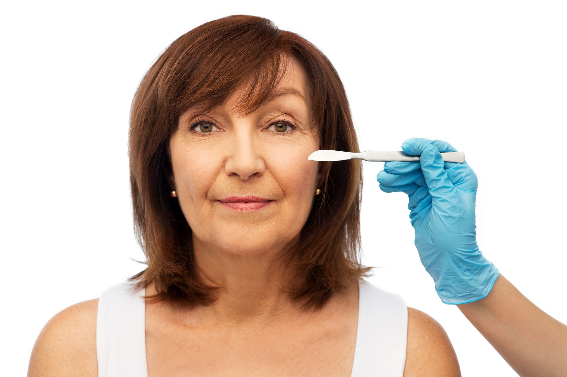 An old woman is getting a Dermaplaning treatment on her face.