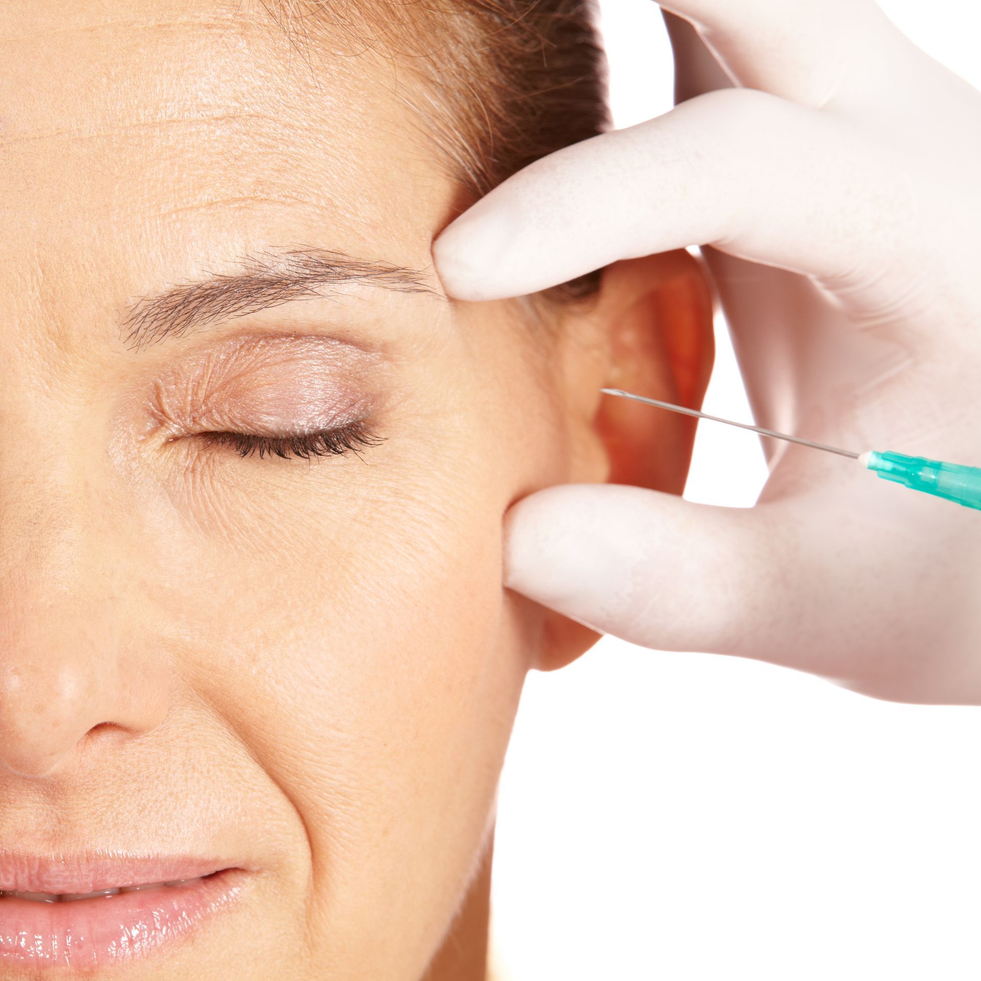 A woman is getting a dysport injection in her forehead