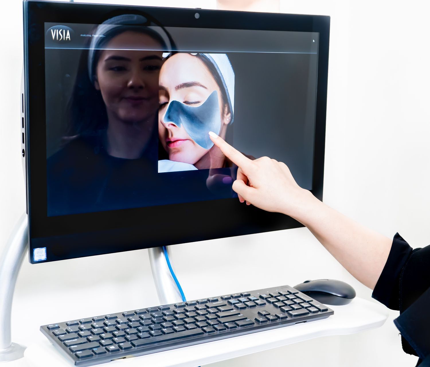 A woman is looking at her complexion analysis.