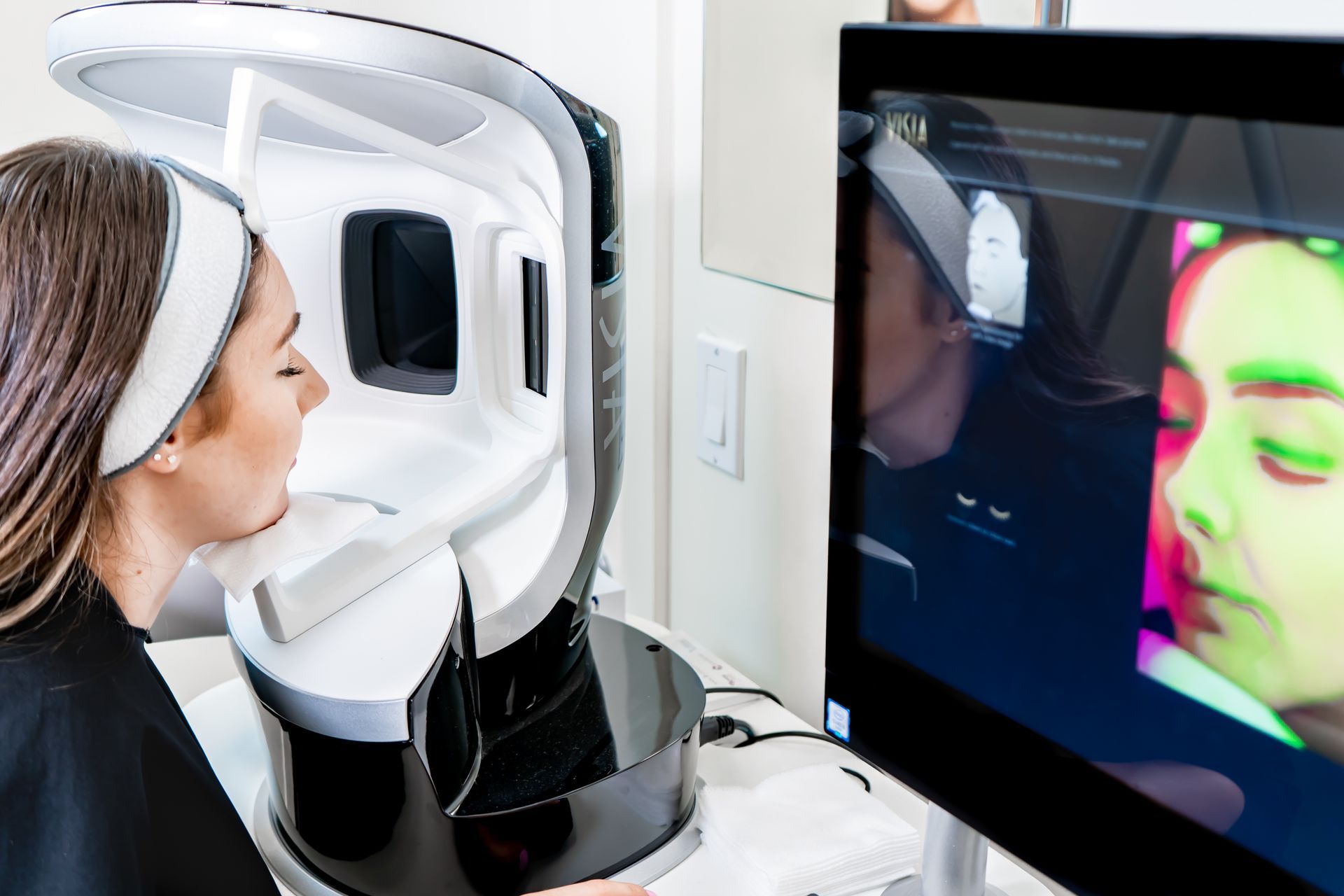 A woman is getting a complexion analysis.