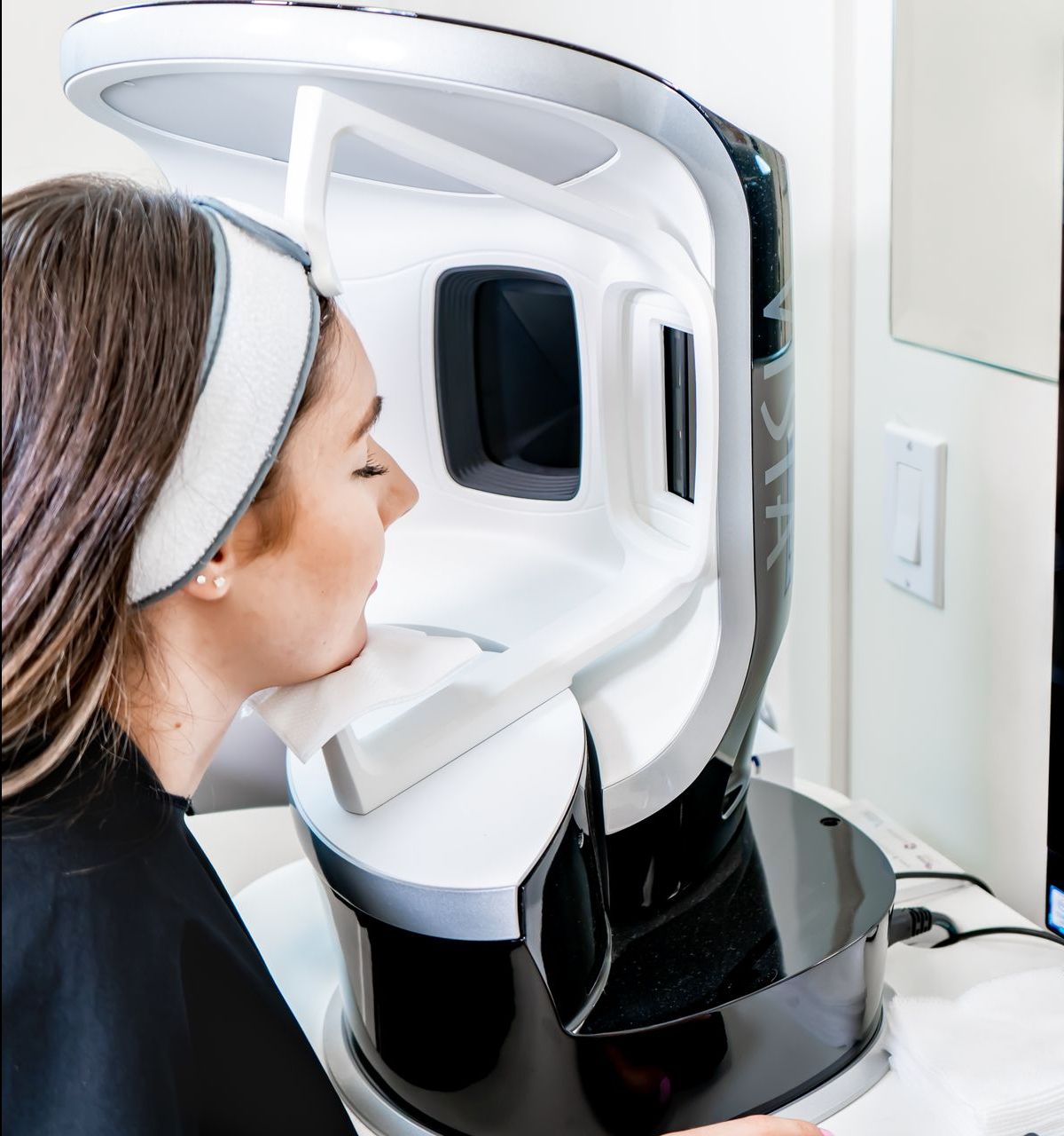 A woman is getting a VISIA complexion analysis.