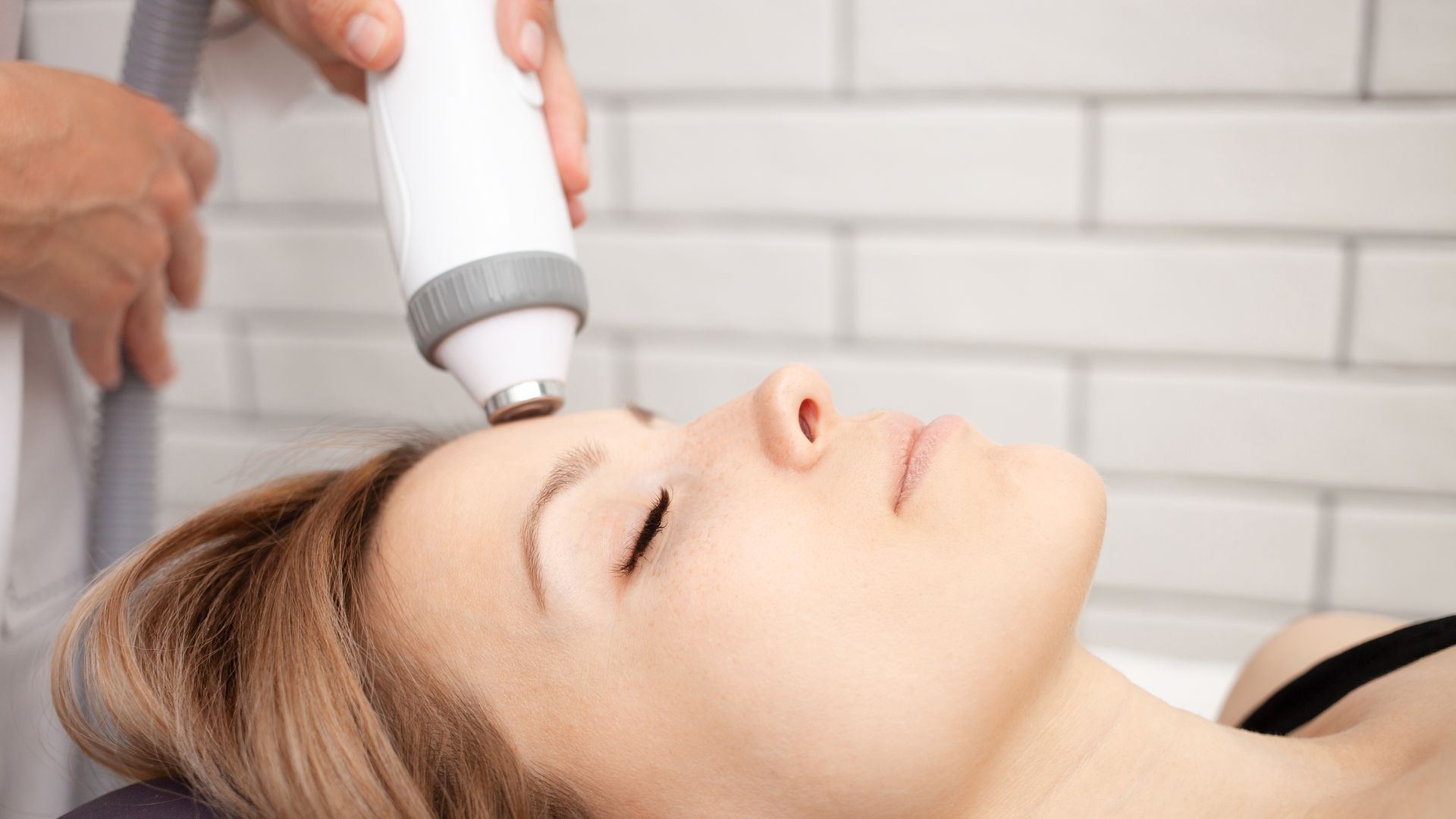 A woman is getting a facial treatment at a beauty salon.