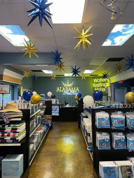 Decorated classroom store aisle with hanging blue and gold star ornaments and shelves of supplies