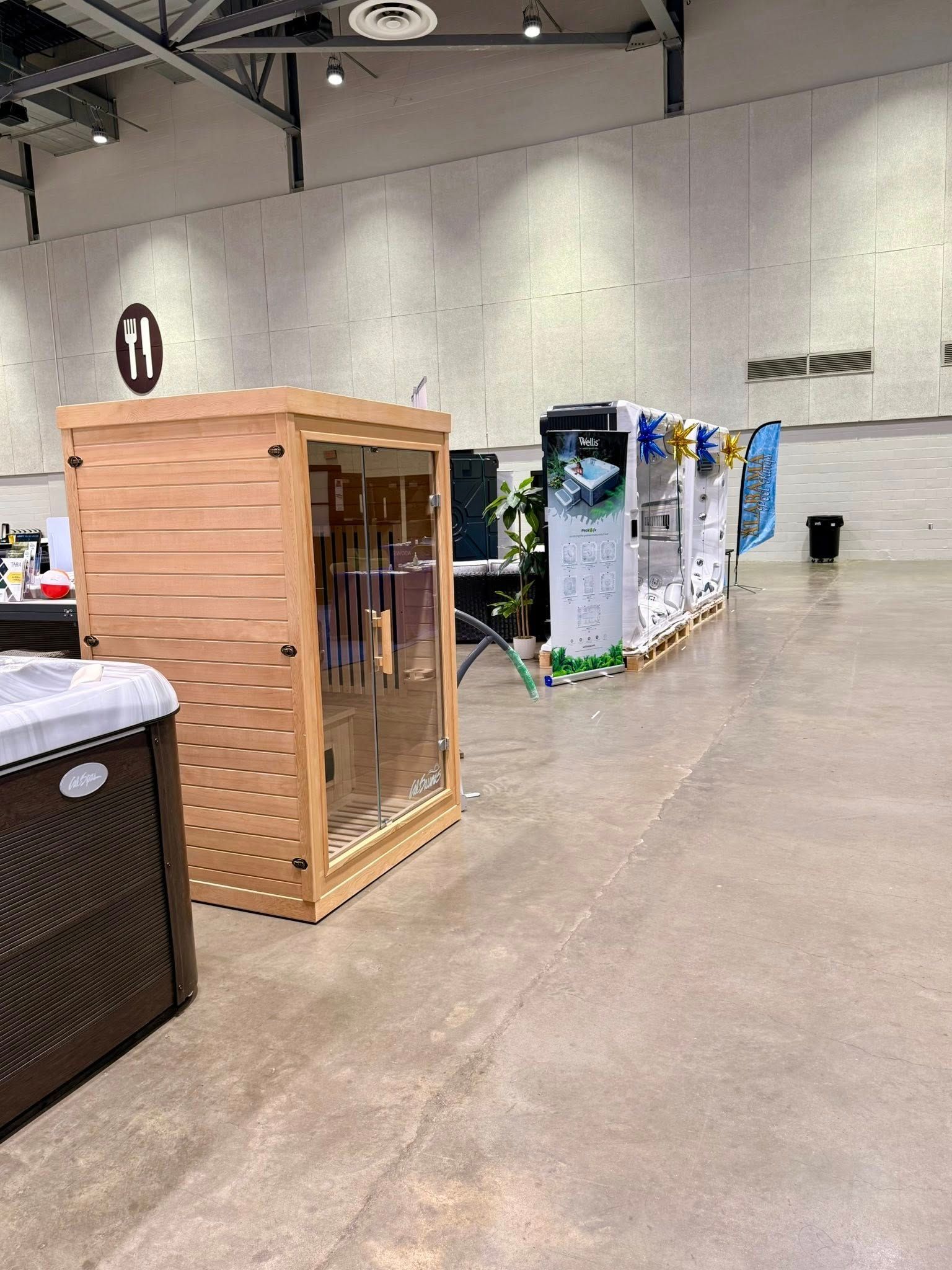 Exhibition hall with wooden cabinets and rows of large display units on a polished concrete floor.