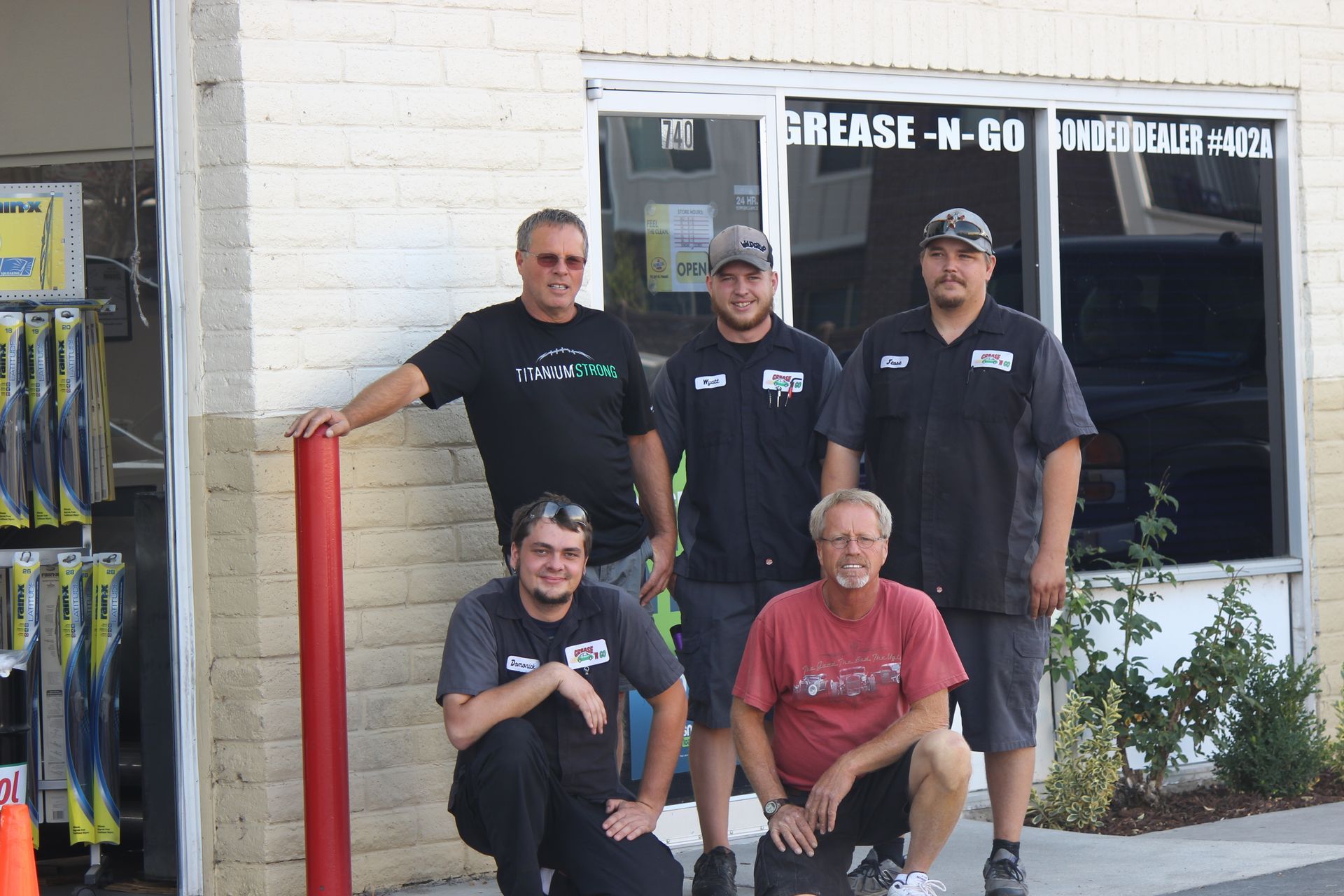Grease N Go team posing for a picture in front of the grease n go shop
