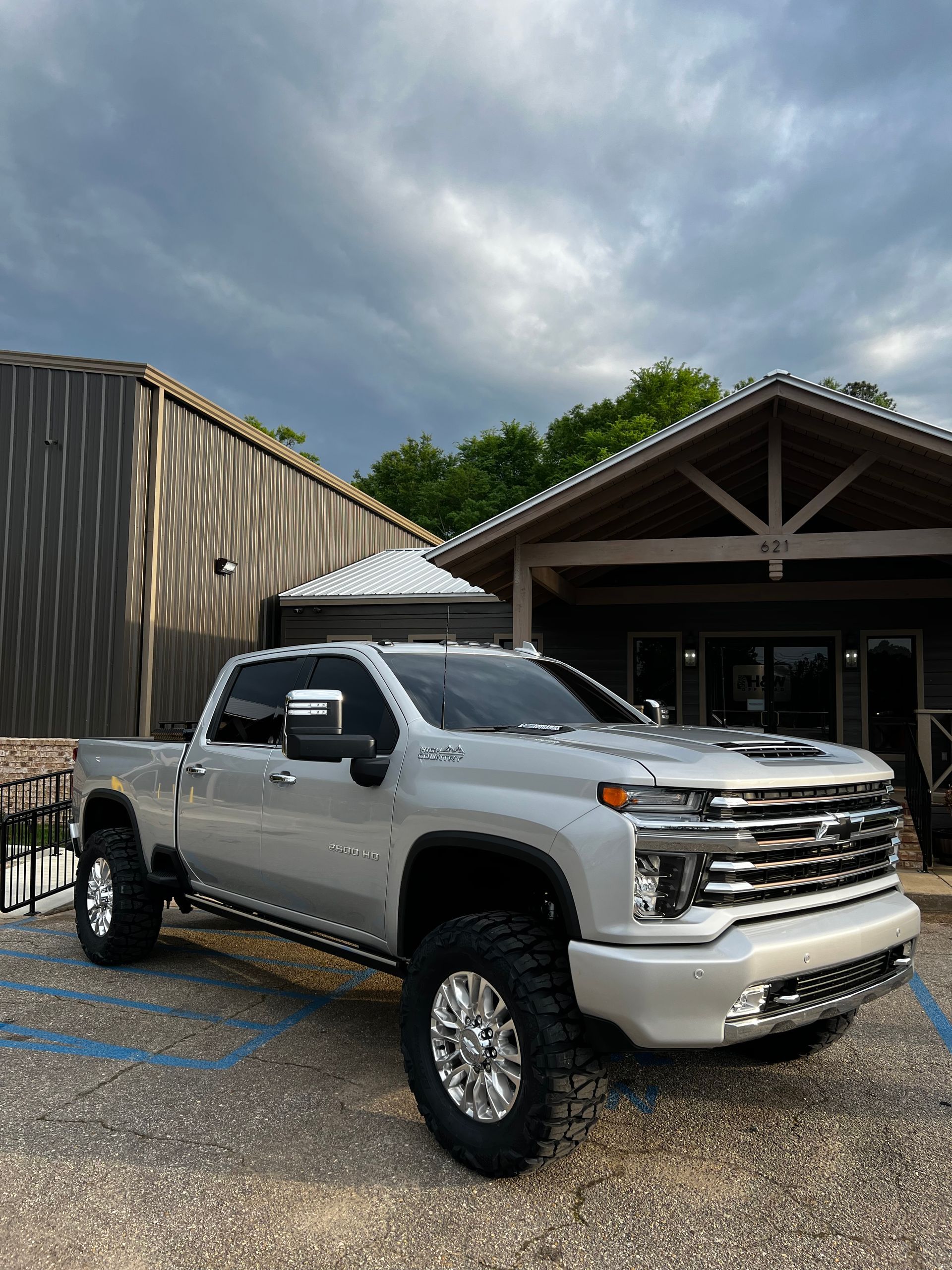 Lifted White GMC Sierra Parked Outside Service Center | Davis Tire Group