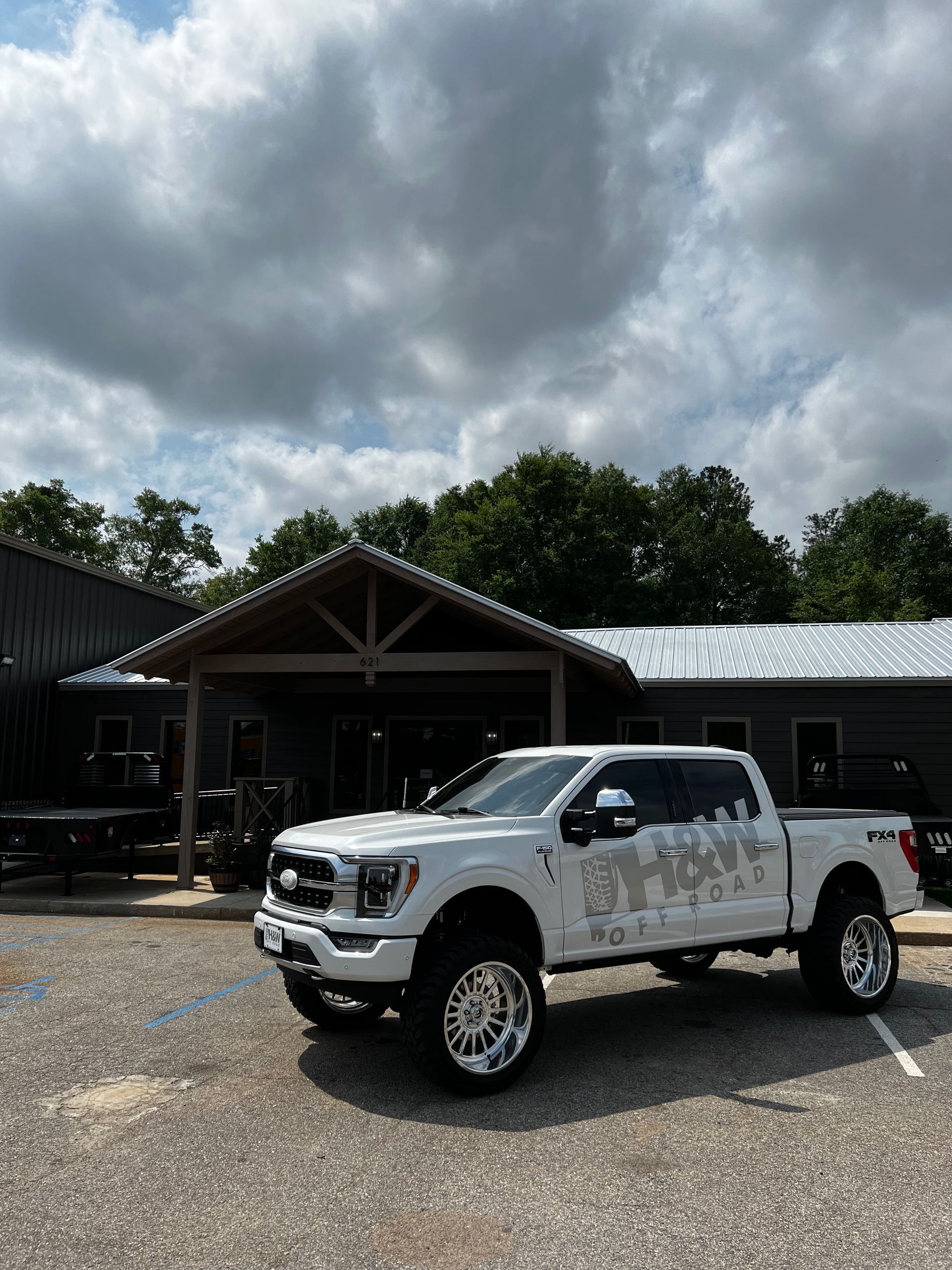 White Chevrolet Silverado Parked In Front Of Auto Shop Building | Davis Tire Group