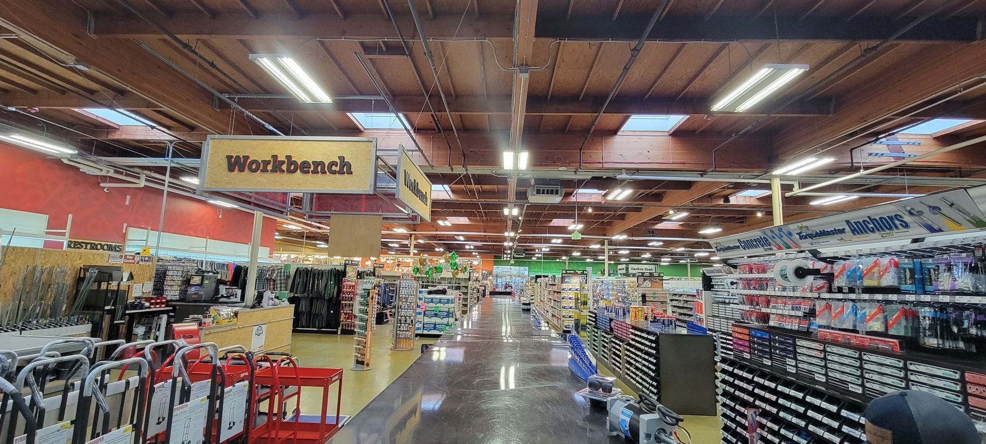 Grocery store aisle with clothing racks, shelves, and a large “Black Friday” sale sign