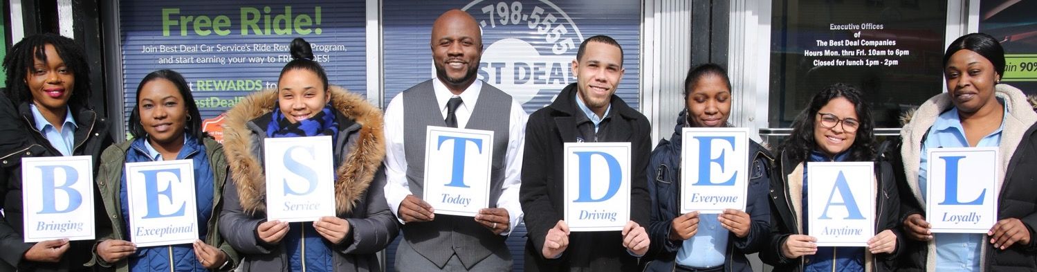 People holding letters spelling “BEST DEAL” at a storefront opening event