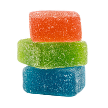 Three colorful sugar-coated gummy candies stacked on a white background