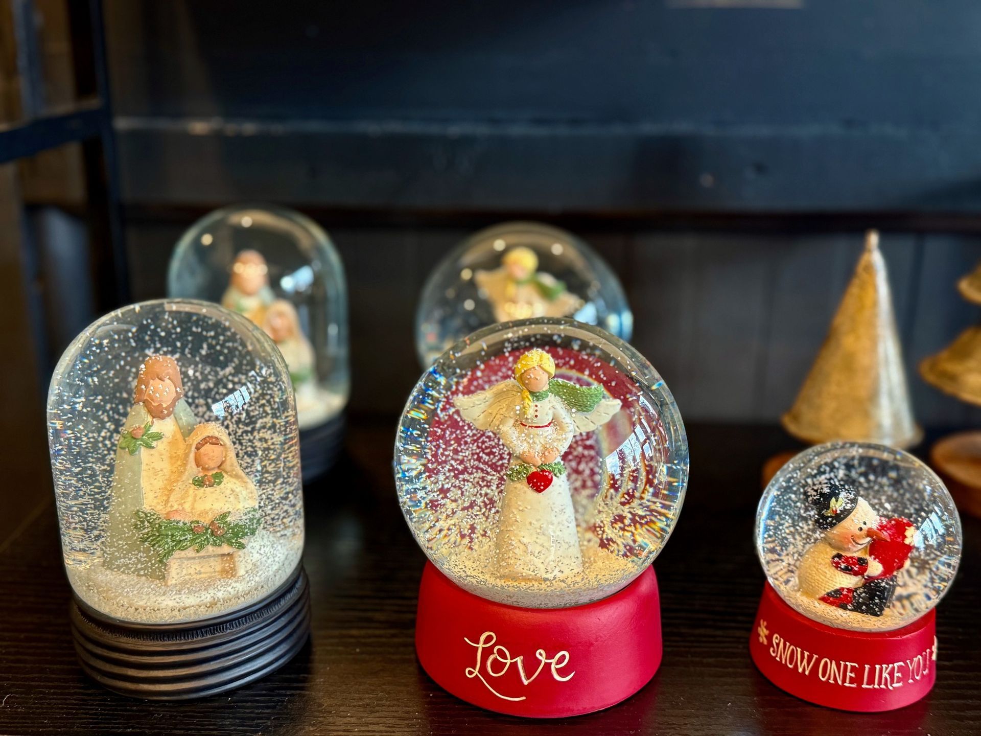 A group of snow globes are sitting on a table.