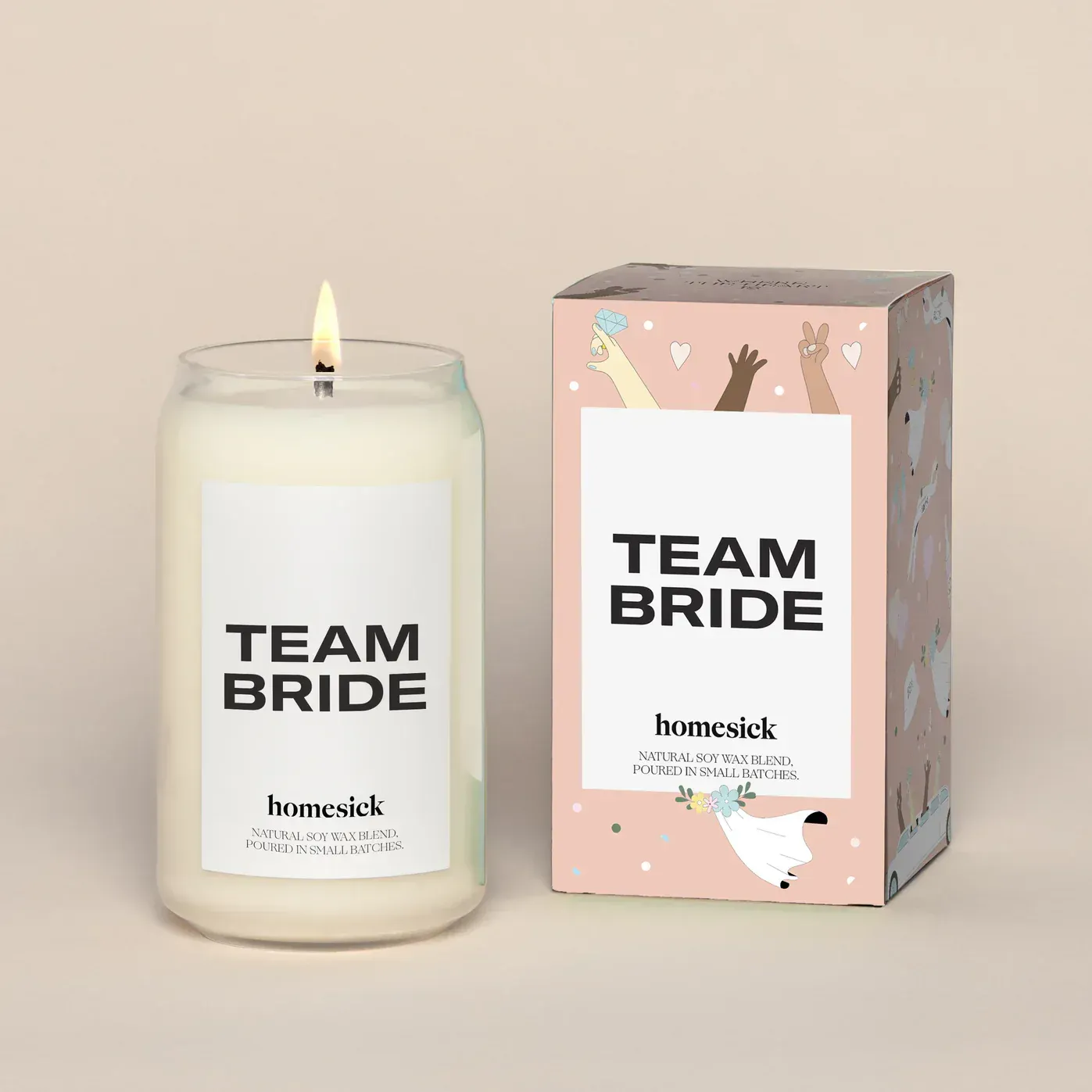 A candle that says team bride next to a box