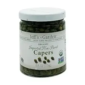 A jar of organic imported non-pared capers on a white background.