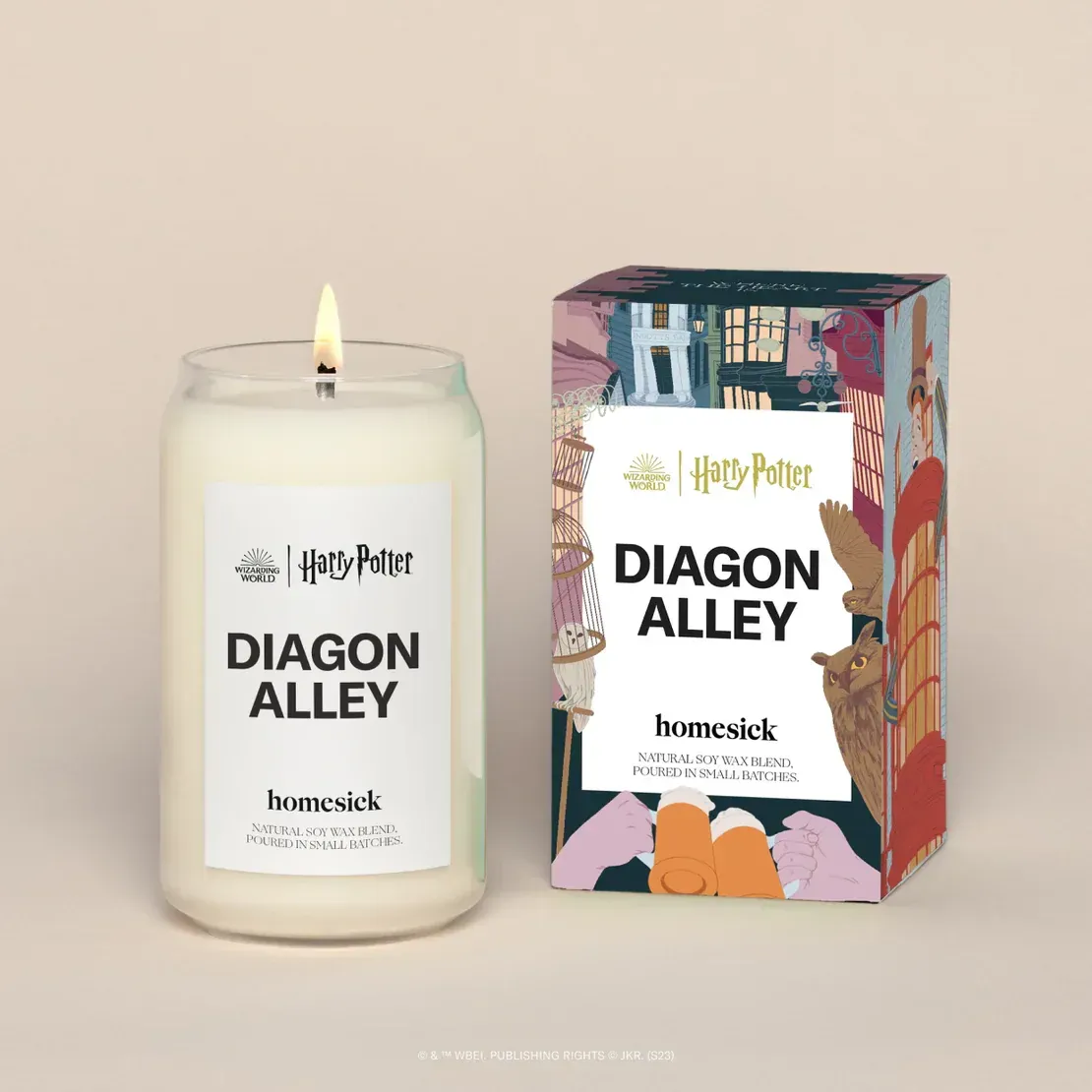 A candle that says ' diagon alley ' on it next to a box