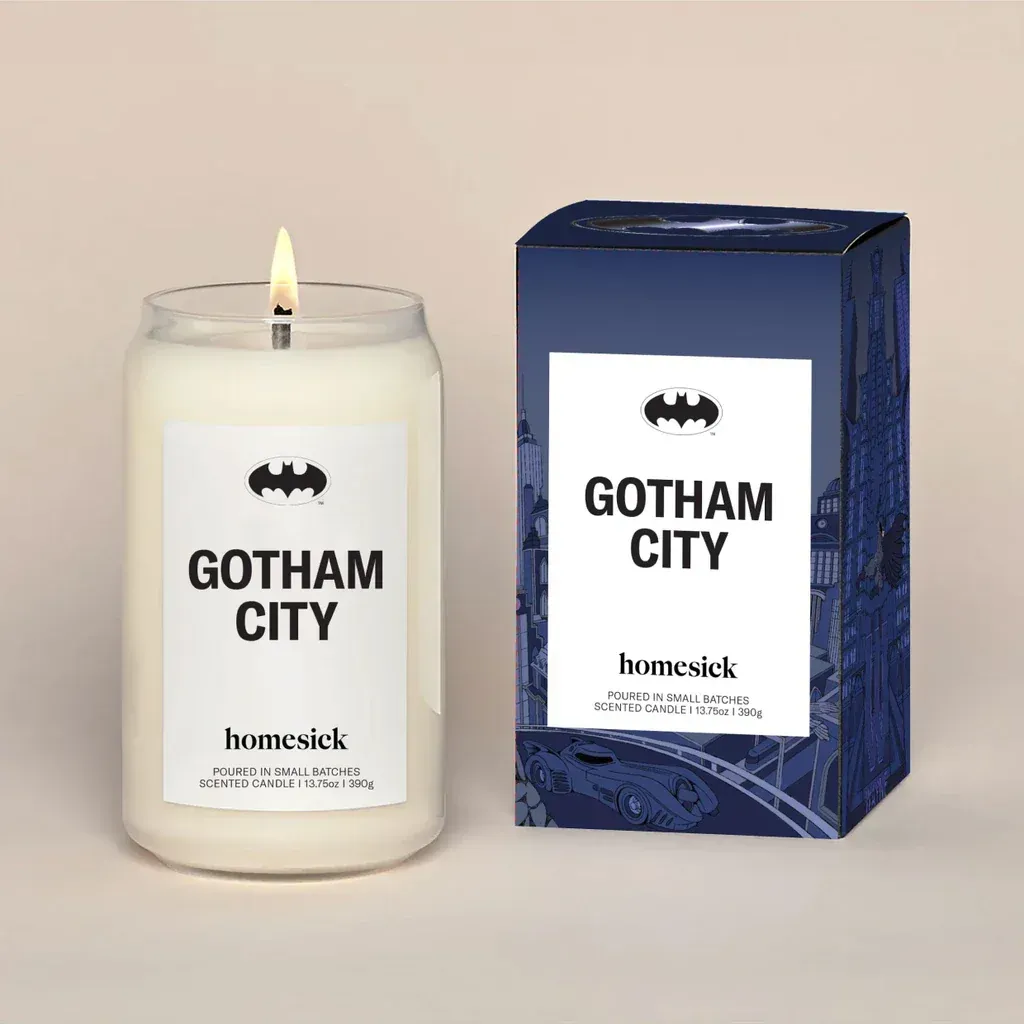 A candle that says gotham city next to a box