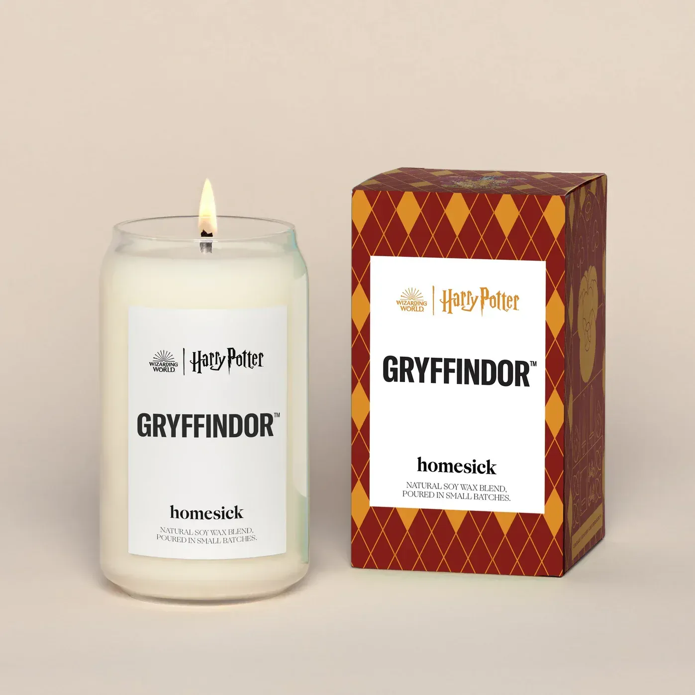 A candle that says gryffindor next to a box