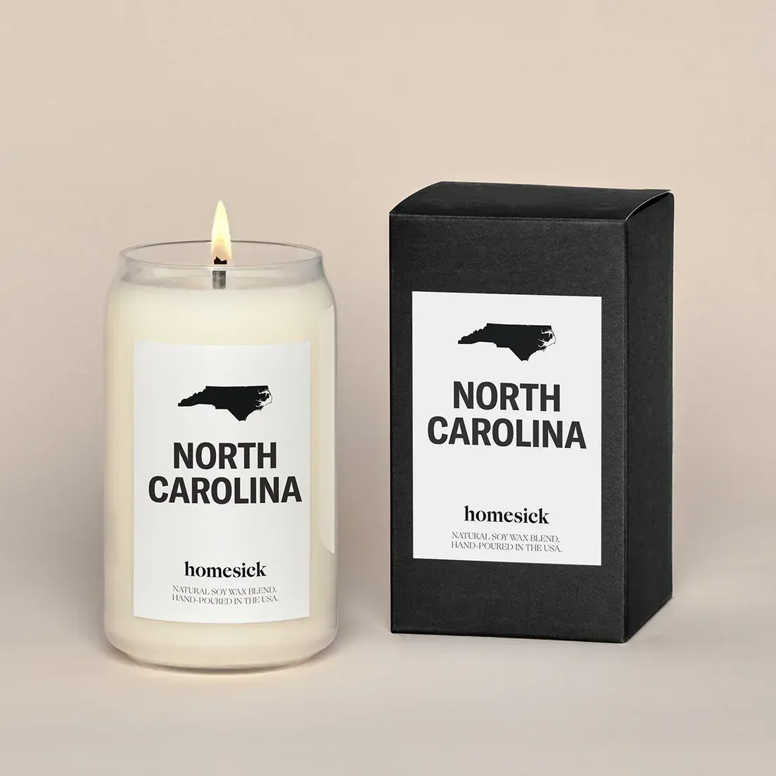 A candle that says north carolina next to a box