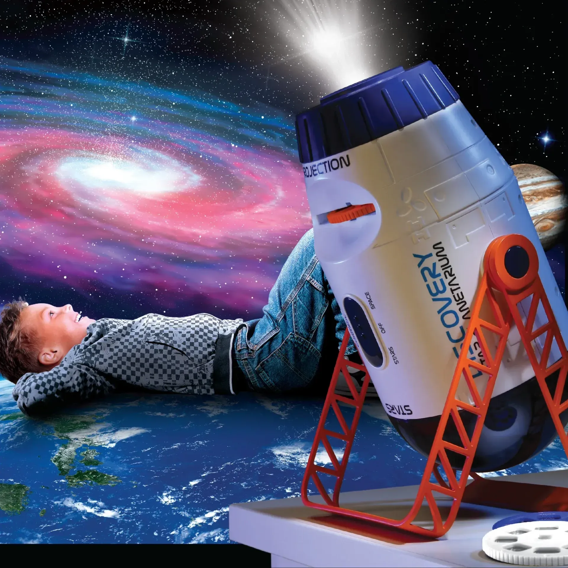 A boy is laying on the ground in front of a recovery projector