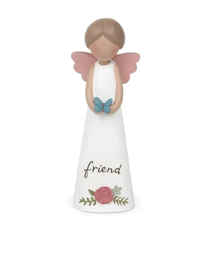 A figurine of an angel with the word friend written on it