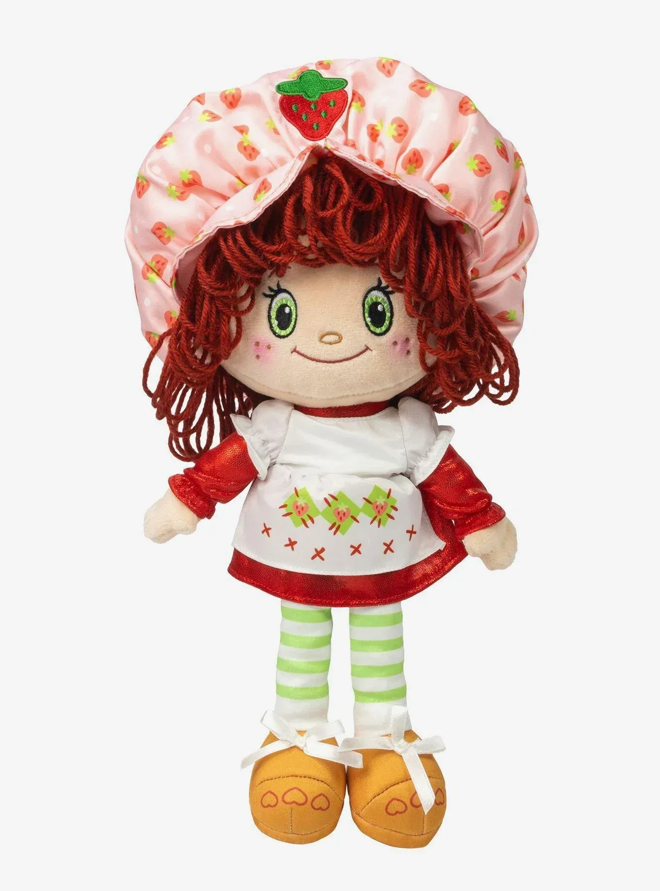 A stuffed strawberry shortcake doll with red hair and a strawberry on her hat.