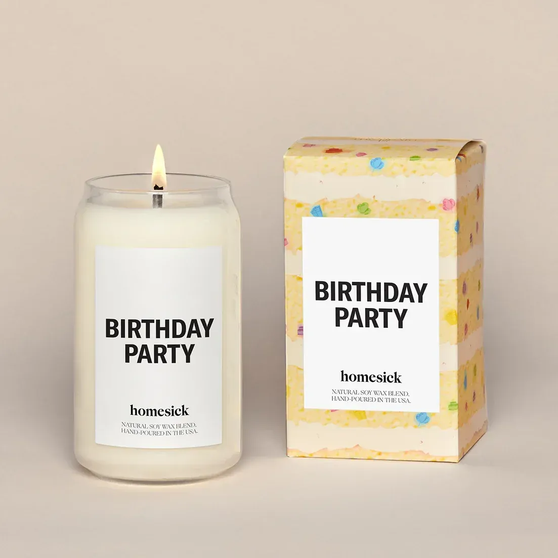 A candle that says birthday party next to a box