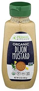 A bottle of organic dijon mustard on a white background.