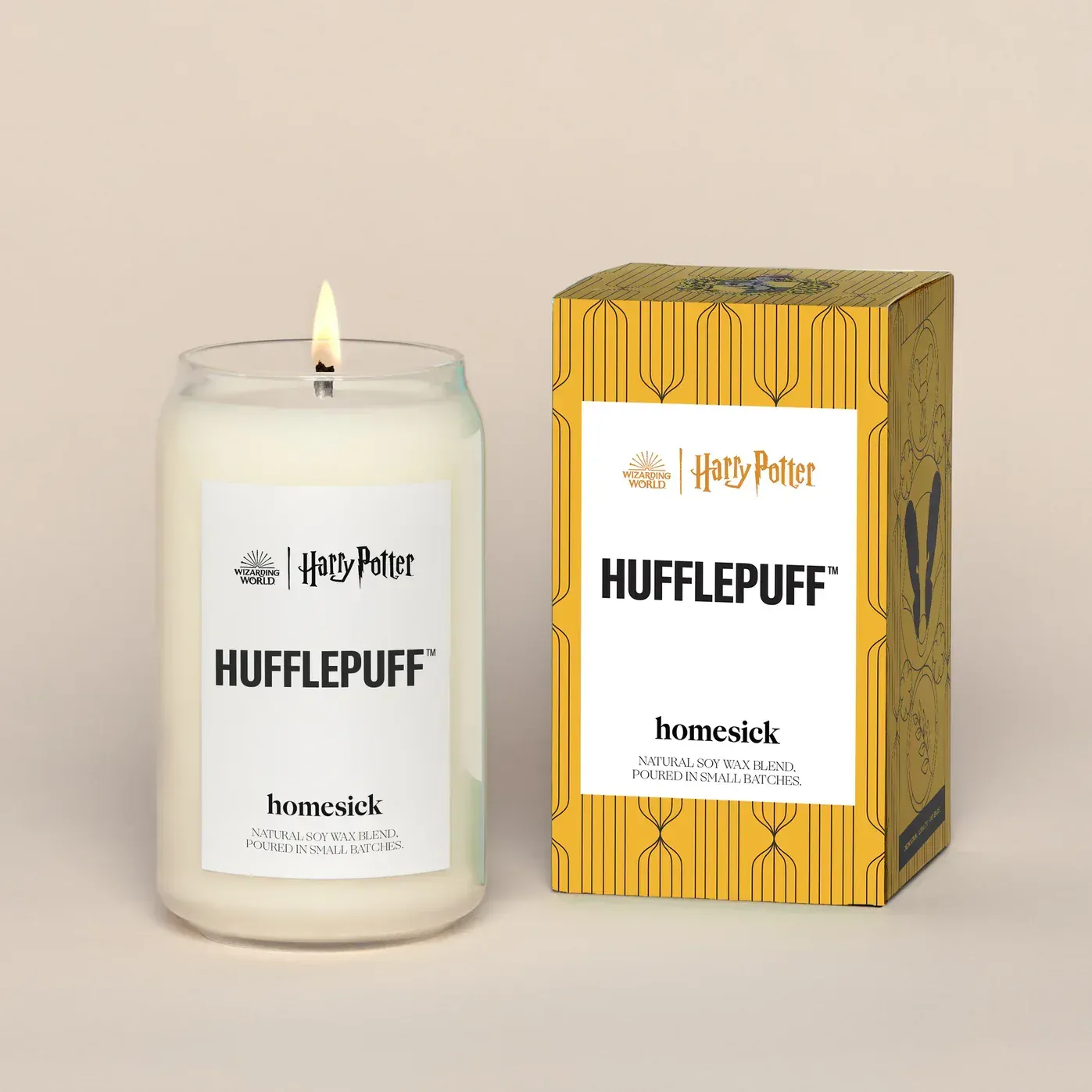 A candle that says hufflepuff next to a box