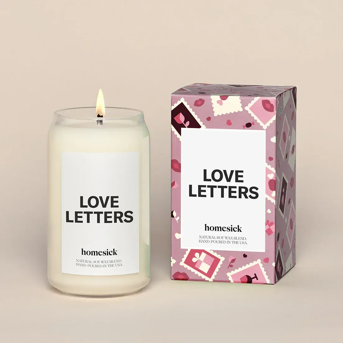 A candle next to a box that says love letters
