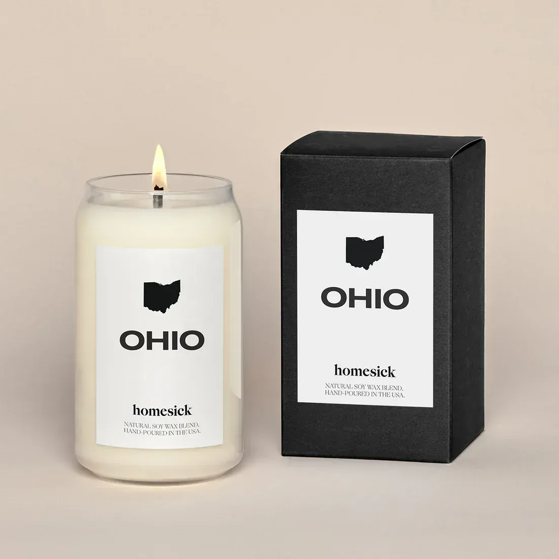 A candle that says ohio next to a box