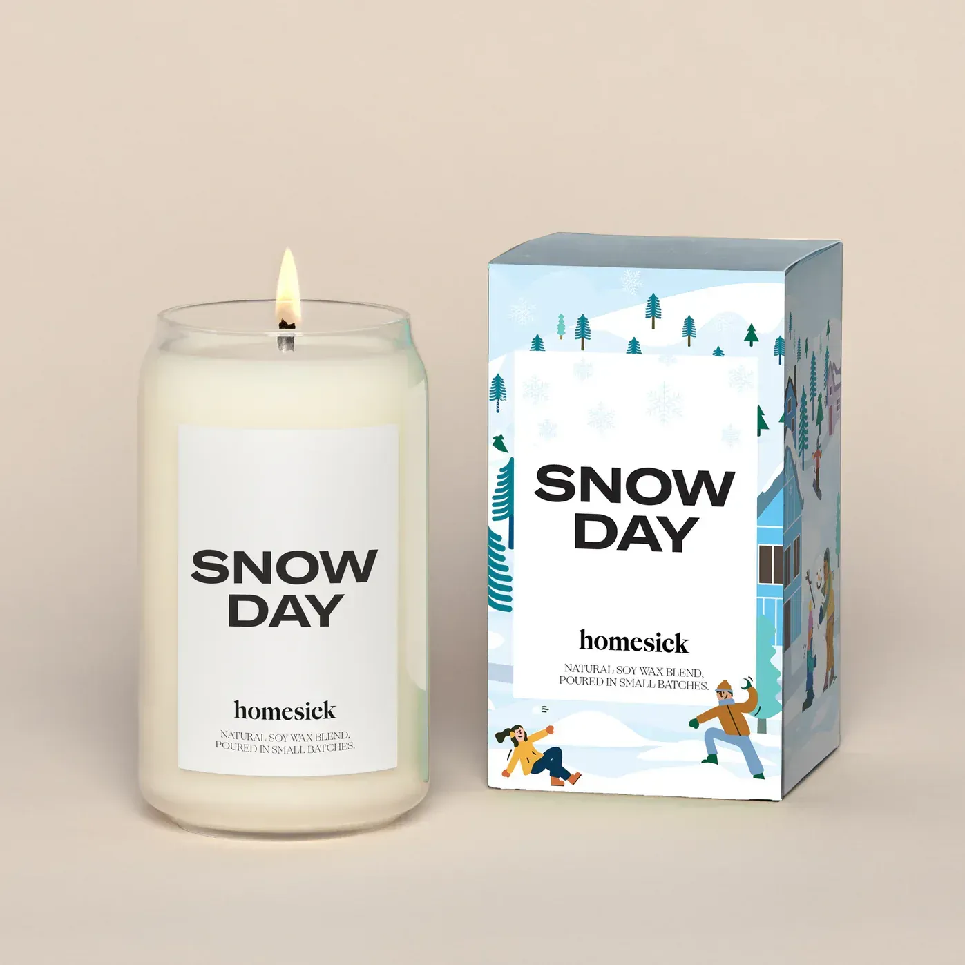 A candle that says snow day next to a box